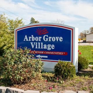 Welcome sign for Arbor Grove Village, showcasing its community features.