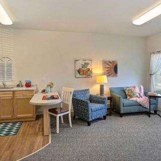A cozy living area with a kitchenette, complete with comfortable seating and modern decor.