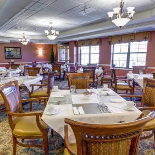 Elegant dining room with neatly arranged tables and chairs.