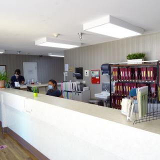 A view of a modern office reception area with a tidy desk and organized files.