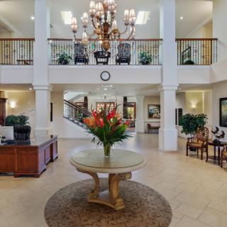 A luxurious lobby with elegant decor and a grand chandelier.