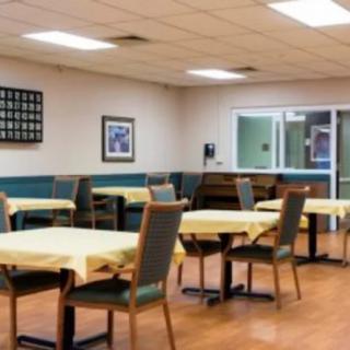 An empty dining room with tables and chairs neatly arranged.