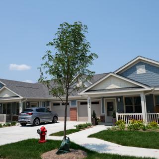 A suburban residential house with a front yard and driveway.
