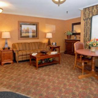 A cozy living room with a sofa, coffee table, and dining area.