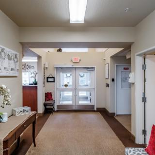 A well-lit hallway with entrance doors and decorative elements.