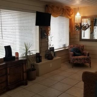 A cozy living room with large windows and comfortable seating.