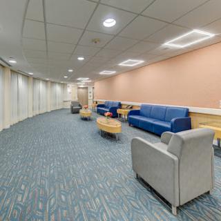 A modern lounge area with comfortable seating arrangements, designed for relaxation and waiting.