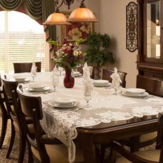 An elegantly set dining room table with fine china and a decorative centerpiece.