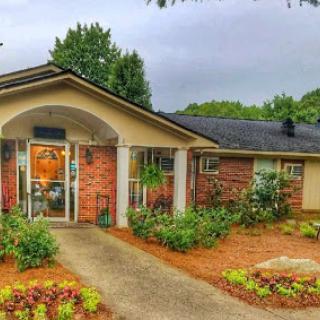 A charming brick home with a well-maintained garden and inviting entrance.