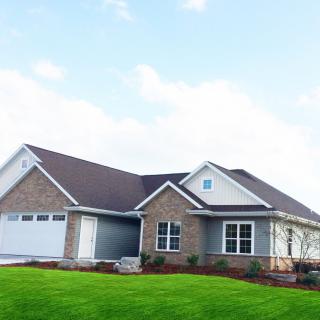A suburban house with a well-maintained lawn and modern architecture.