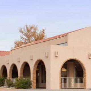 A Mediterranean-style building with a row of arches and a sunny exterior.