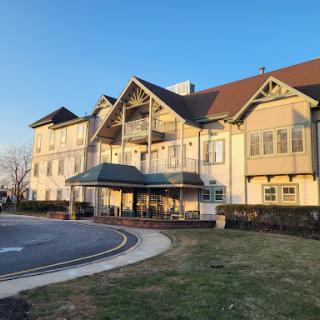 A modern hotel with a welcoming entrance in the warm light of sunset.