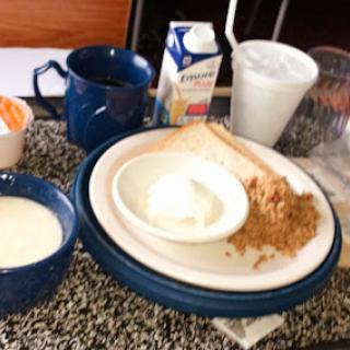 A simple breakfast setup featuring various food items on a table.