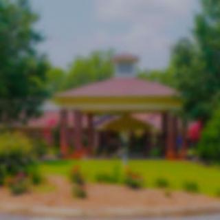 A beautiful pavilion surrounded by lush greenery and vibrant flowers.