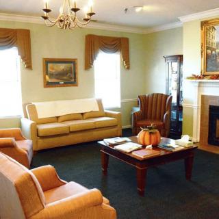 A well-furnished living room with comfortable seating and a cozy fireplace.