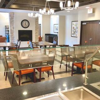 A modern dining area with comfortable seating, elegant chandeliers, and tasteful decor.