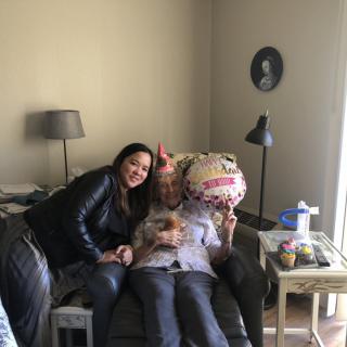 A cozy family celebration in the living room with a balloon.