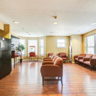 A spacious waiting room with comfortable seating and large windows.