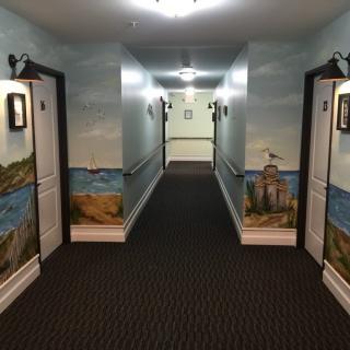 A hallway adorned with colorful murals of nature scenes on the doors.