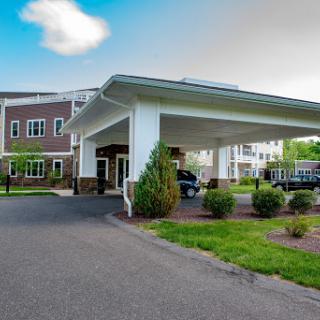 A welcoming entrance to a modern building with landscaped surroundings.