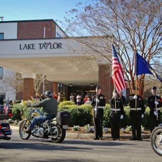 A community parade at Lake Taylor with motorcycles and an honor guard paying tribute.