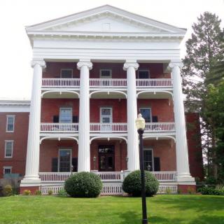 A historic building with prominent white columns and a brick facade.