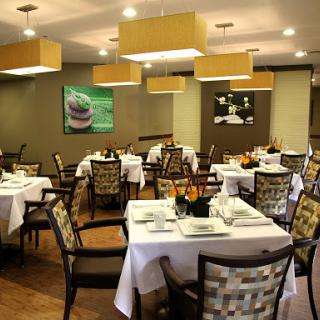 A cozy dining area with neatly arranged tables and chairs, perfect for an inviting meal.