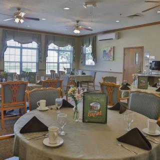 A restaurant dining area with neatly arranged tables and chairs.