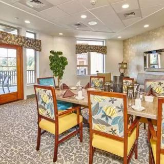 A cozy dining room with colorful chairs and a well-set table in a bright, inviting space.