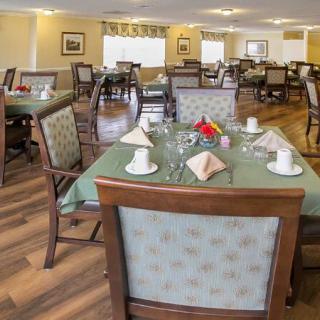 A well-arranged dining area with neatly set tables and comfortable seating.