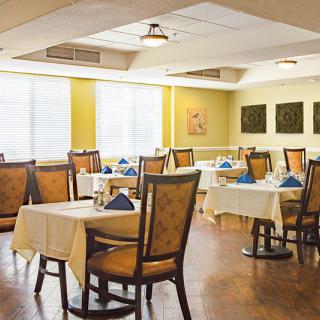 A well-arranged restaurant dining area with neatly set tables and chairs.