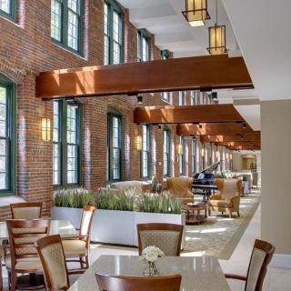 A spacious and modern dining area with stylish furniture and large windows.