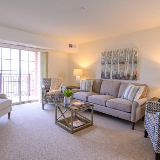 A cozy living room with a comfortable sofa, armchairs, and stylish decor.
