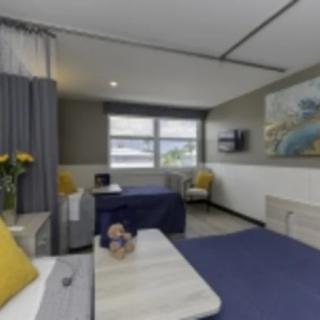 A modern hotel room with stylish furnishings and yellow accent details.