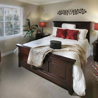 A cozy bedroom with elegant decor and warm lighting.