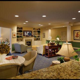 A cozy basement living room with comfortable furniture and warm lighting.