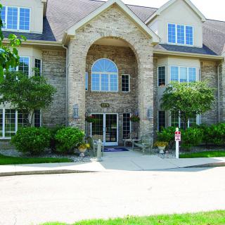 A large residential building with a brick exterior and multiple windows.
