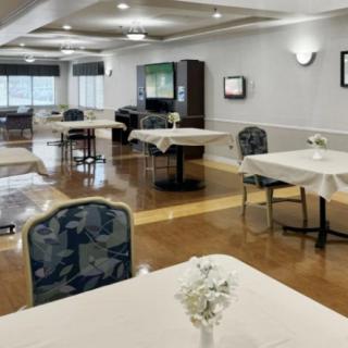 An empty dining area with neatly arranged tables and chairs.