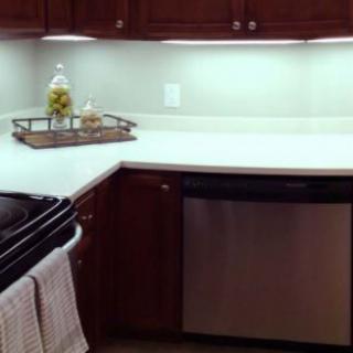 Modern kitchen with wooden cabinets and a stainless steel dishwasher.