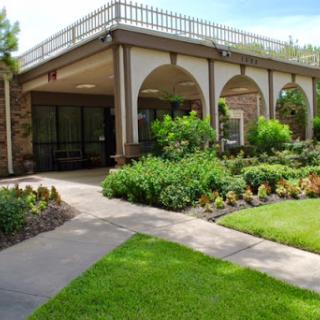 A beautiful architectural structure surrounded by lush landscaping and gardens.