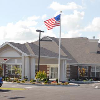 A well-maintained residential building proudly displaying the American flag.