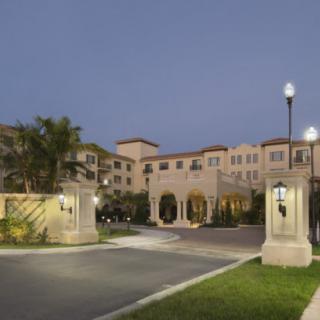 A well-lit residential building entrance at dusk.