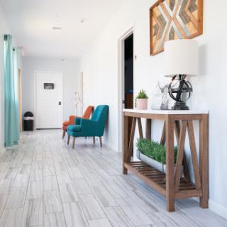 A bright and modern hallway featuring colorful seating and stylish decor.