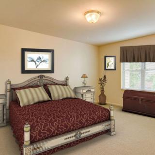 A well-decorated bedroom with a large bed, bedside table, and window.