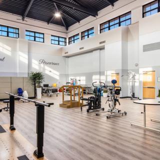 A spacious and well-lit fitness center equipped with various exercise machines and modern facilities.