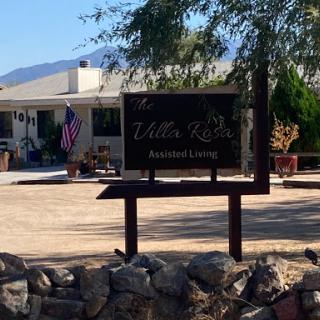 Entrance to a facility named 'Little Tree' with a sign and surrounding landscape.