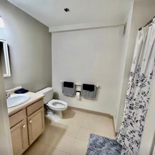 A clean and modern bathroom featuring essential fixtures and tasteful decor.