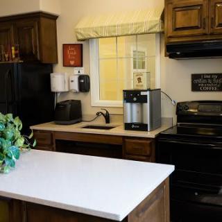 A cozy kitchen with modern appliances and wooden cabinetry.