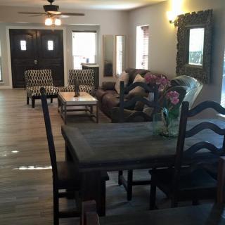 A spacious living and dining area with modern furniture and decor.