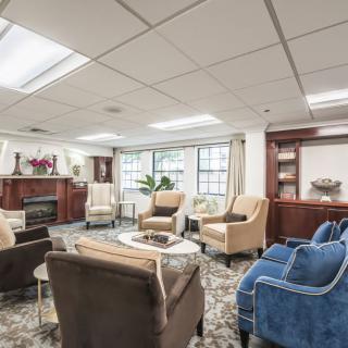 A cozy living room with ample seating arrangements and a fireplace.